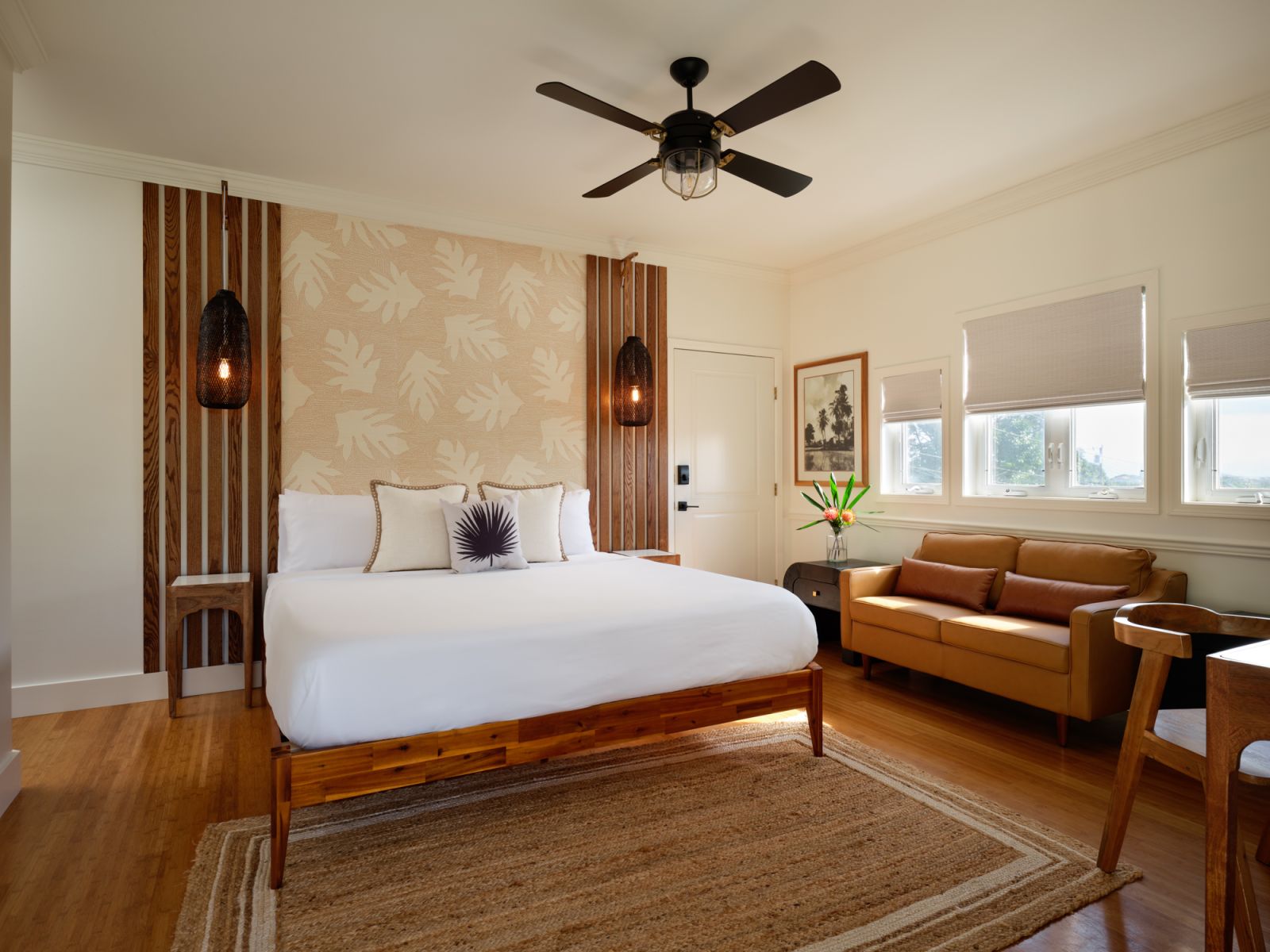 A sophisticated suite with palm wallpaper and library shelving